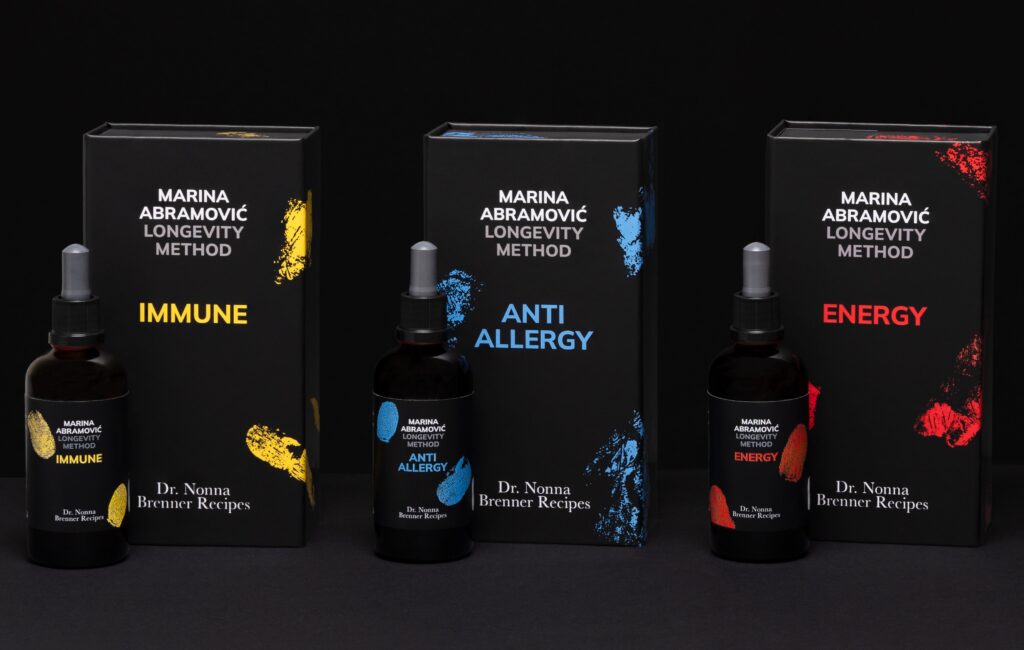 Complete range of Marina Abramović Longevity Method wellness products displayed side by side against a dark background.